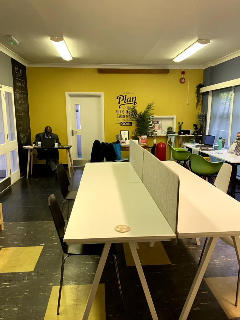 Open-plan workspace with long desks and collaborative setup