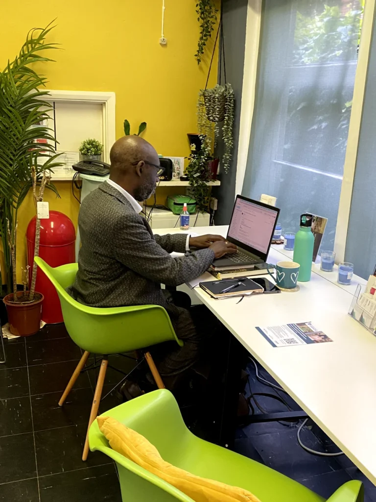 Man working on laptop at shared desk in LondonBP workspace