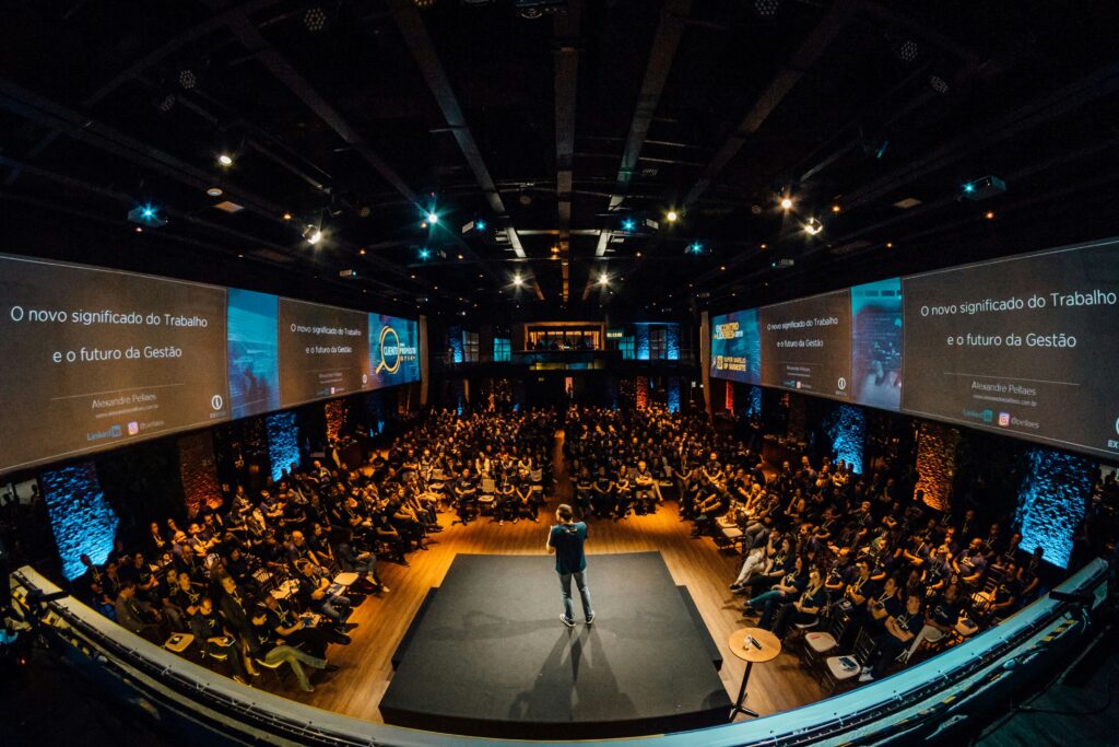 Speaker presenting to a packed audience at a business leadership and future of work conference in London